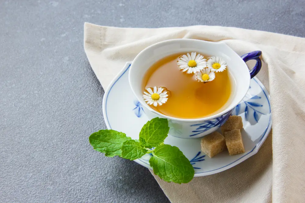 Steaming cup of chamomile tea with honey for sore throat relief