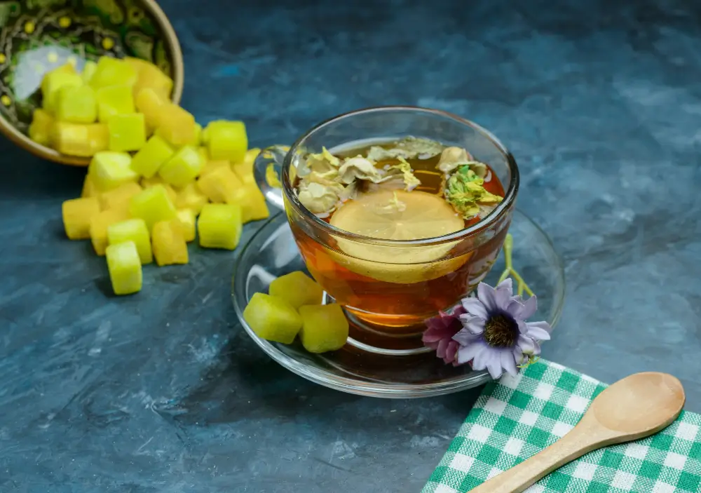 Steaming cup of elm tea with honey for sore throat relief