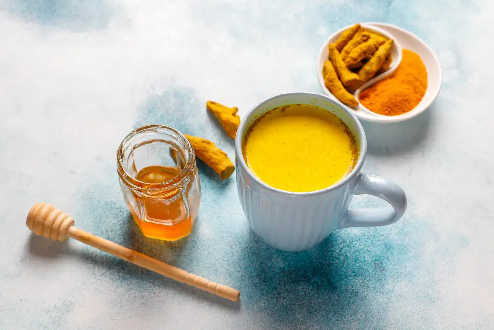 Steaming cup of Turmeric tea with honey for sore throat relief
